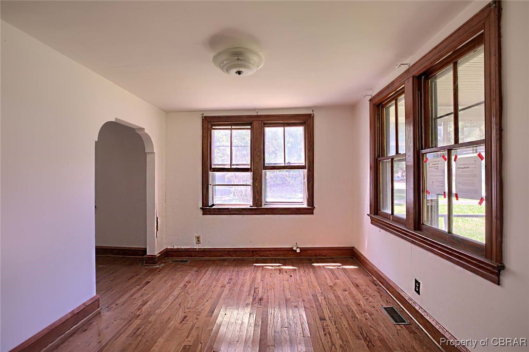 708 Calthrop Neck Road Yorktown, VA 23693 - Photo 7 of 24 Empty room featuring dark wood-style flooring and arched walkways