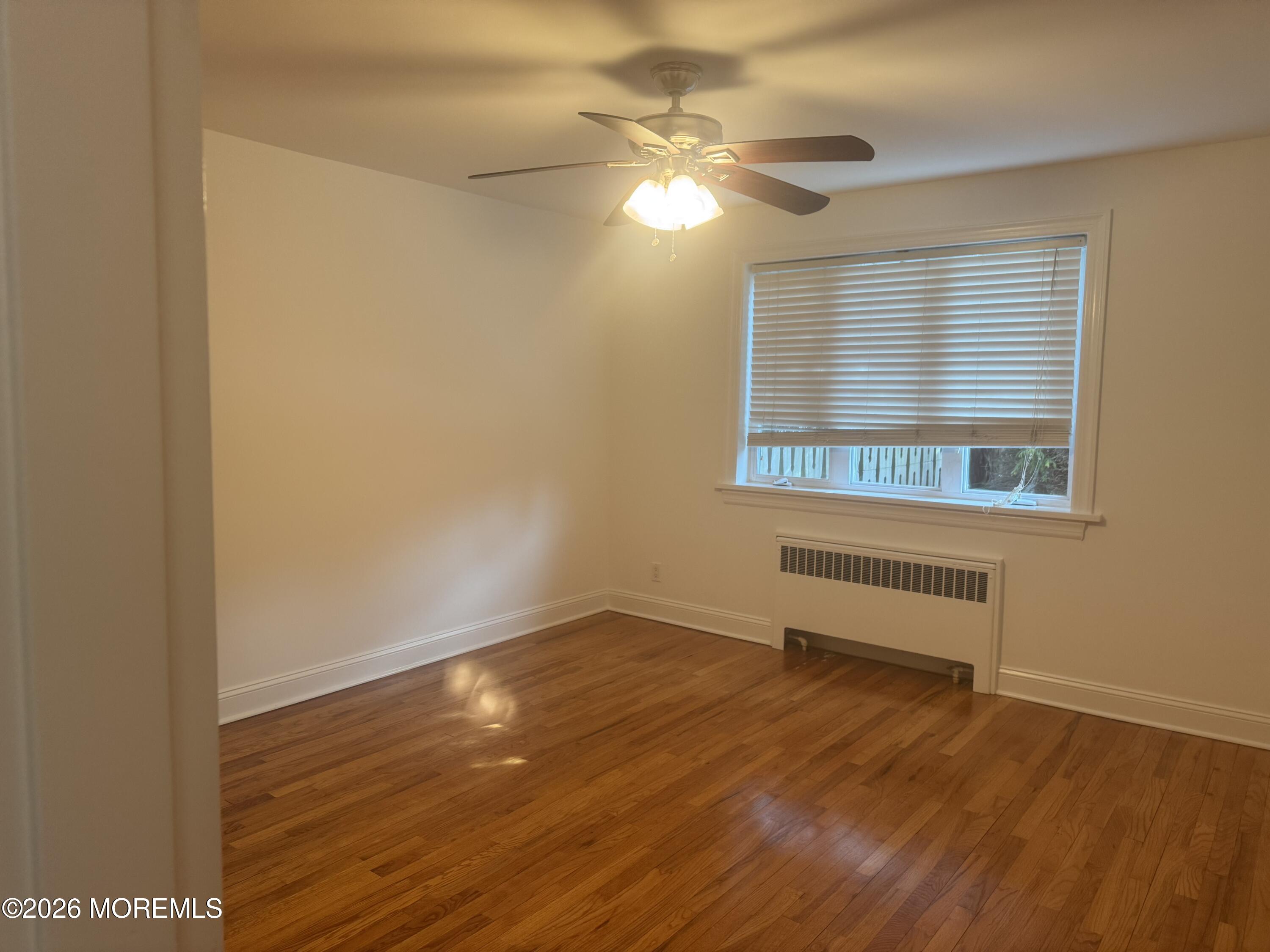283 Spring Street, Unit 5B Red Bank, NJ 07701 - Photo 14 of 18 a view of a room with wooden floor and fan