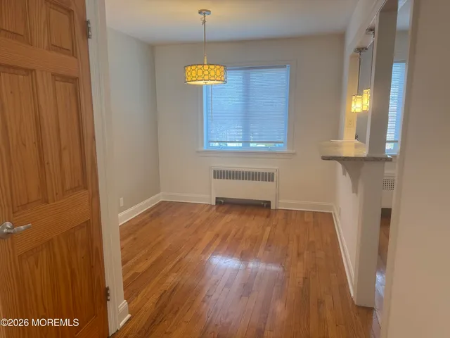 a view of front door with wooden floor