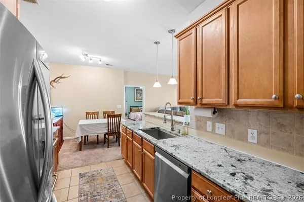 a kitchen with stainless steel appliances granite countertop a sink stove and cabinets