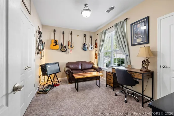 a view of a livingroom with workspace and a window