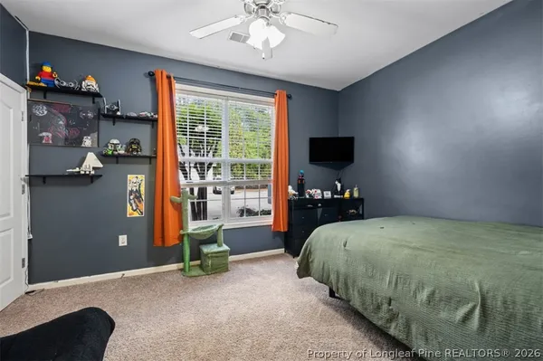 a bed room with a bed and a television
