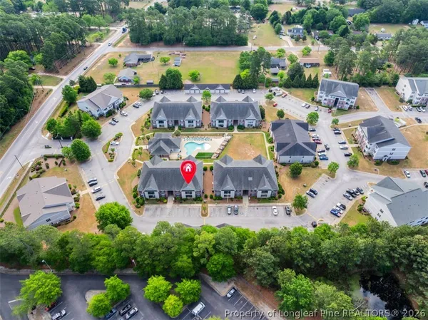 an aerial view of a houses with outdoor space and pool