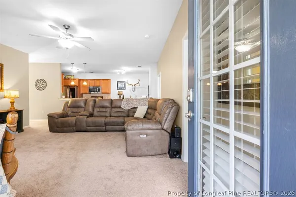 a living room with furniture and a chandelier