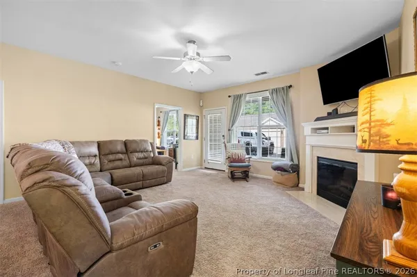 a living room with furniture fireplace and a flat screen tv