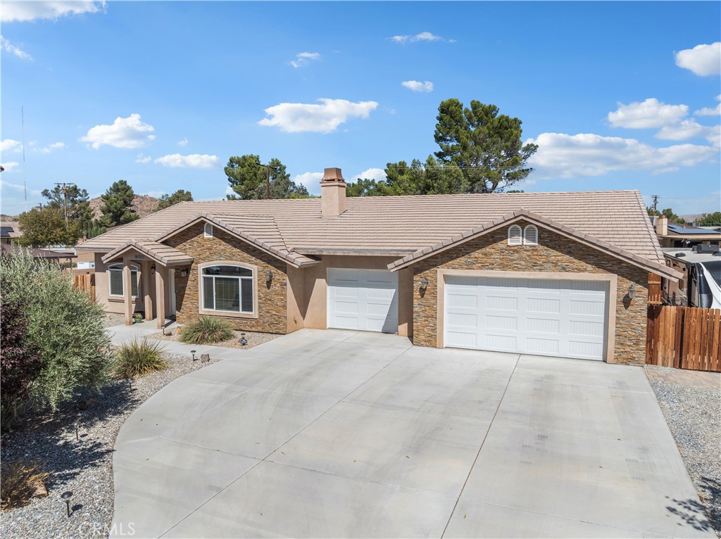 14385 Crow Road Apple Valley, CA 92307 - Photo 1 of 1 a front view of a house with a yard and garage