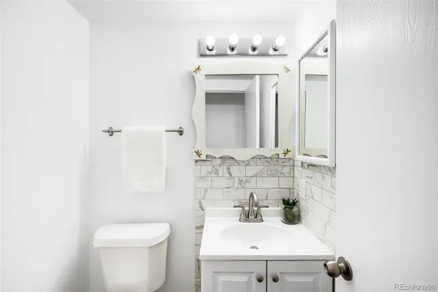 a bathroom with a sink a toilet and mirror