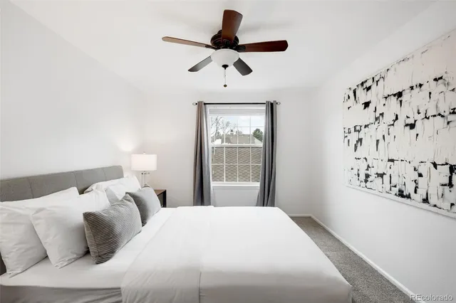 a bedroom with a bed and a white cabinet