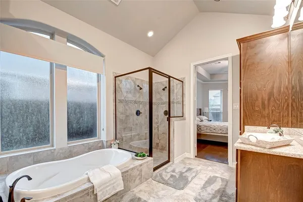 a view of a patio with table and chairs and floor to ceiling window