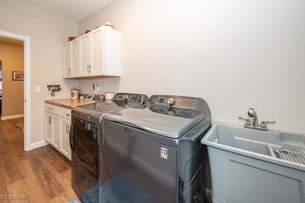 6580 Abbey Road North Canfield, OH 44406 - Photo 21 of 32 Laundry area with dark wood finished floors, washing machine and clothes dryer, and cabinet space