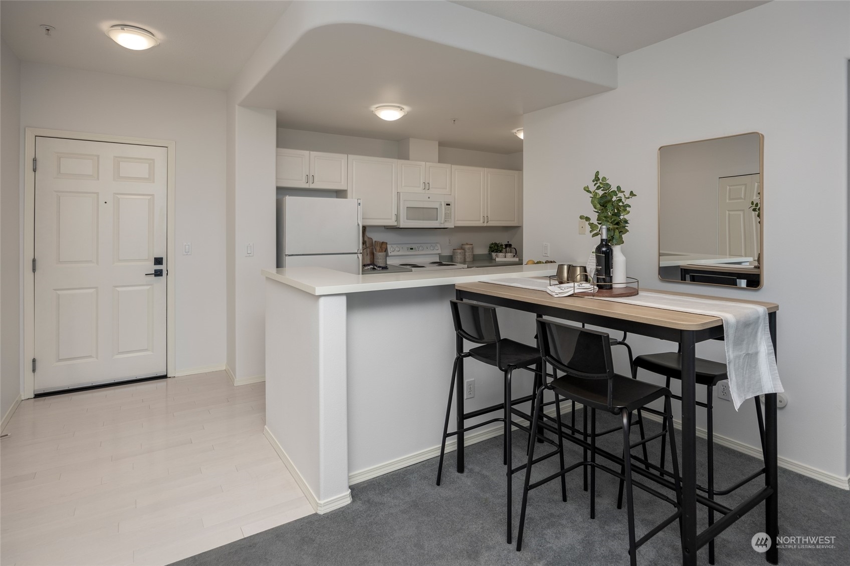 3221 Southwest Avalon Way, Unit 305 Seattle, WA 98126 - Photo 13 of 40 a kitchen with a table and chairs in it