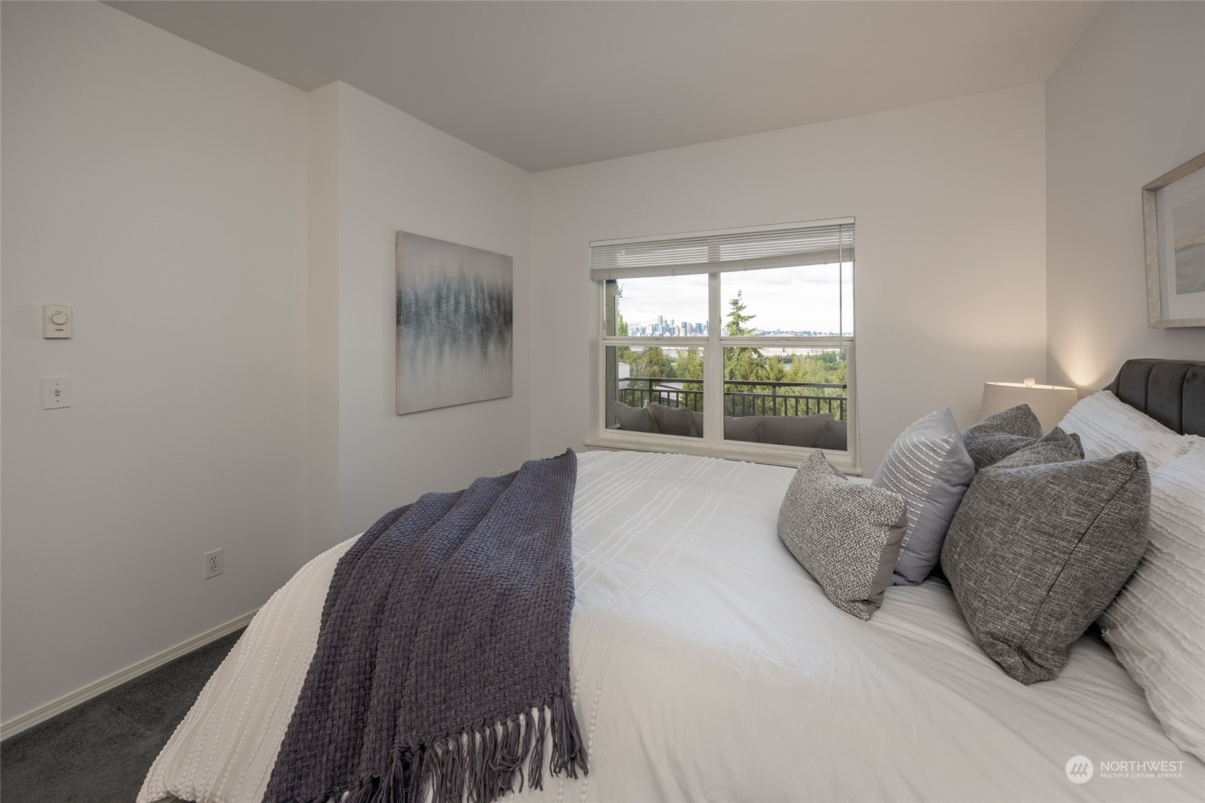 3221 Southwest Avalon Way, Unit 305 Seattle, WA 98126 - Photo 19 of 40 a large bed sitting in a bedroom next to a window