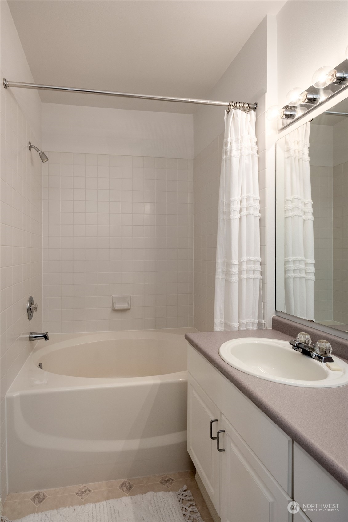 3221 Southwest Avalon Way, Unit 305 Seattle, WA 98126 - Photo 21 of 40 a bathroom with a granite countertop sink and a bathtub