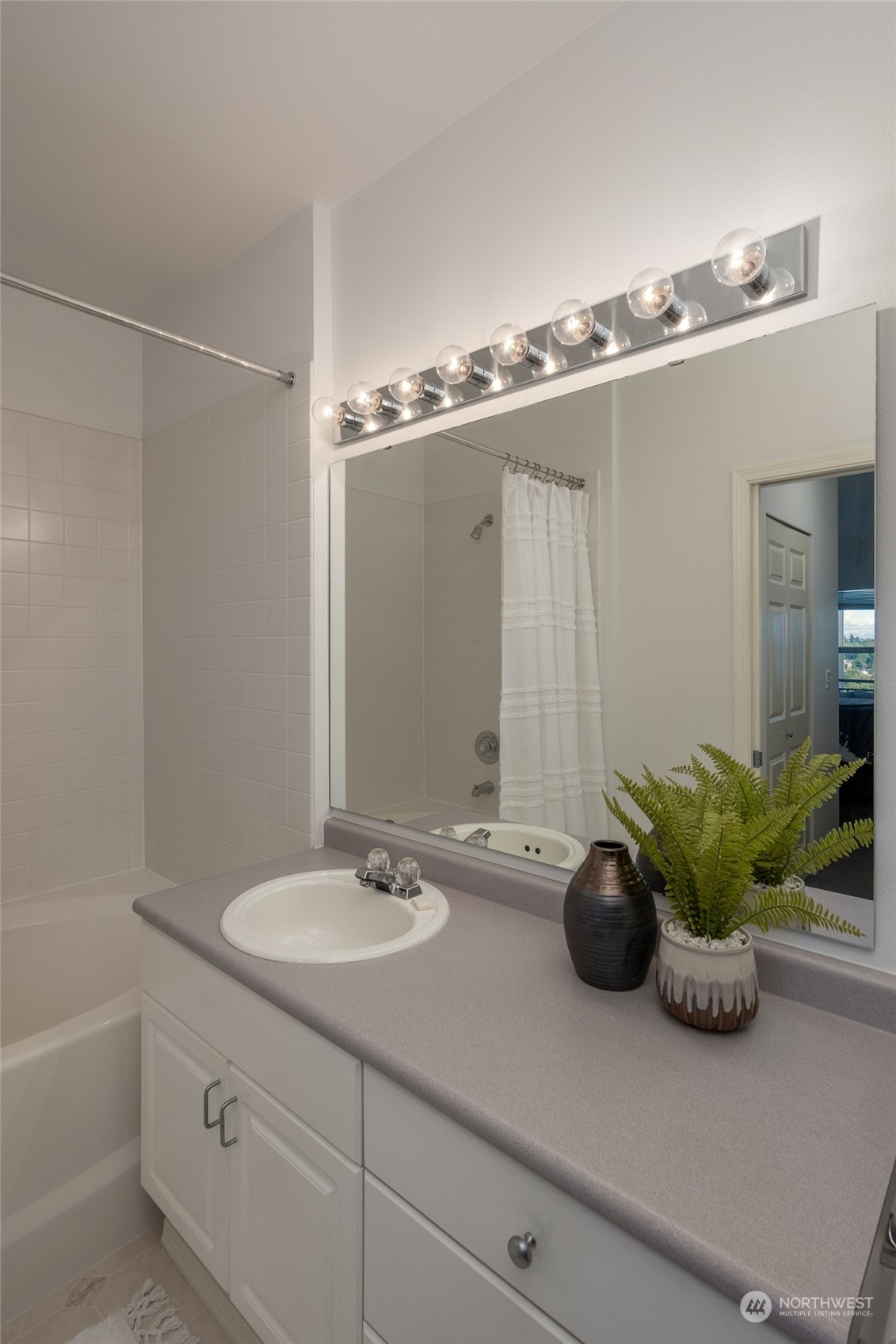 3221 Southwest Avalon Way, Unit 305 Seattle, WA 98126 - Photo 22 of 40 a bathroom with a granite countertop sink and a mirror