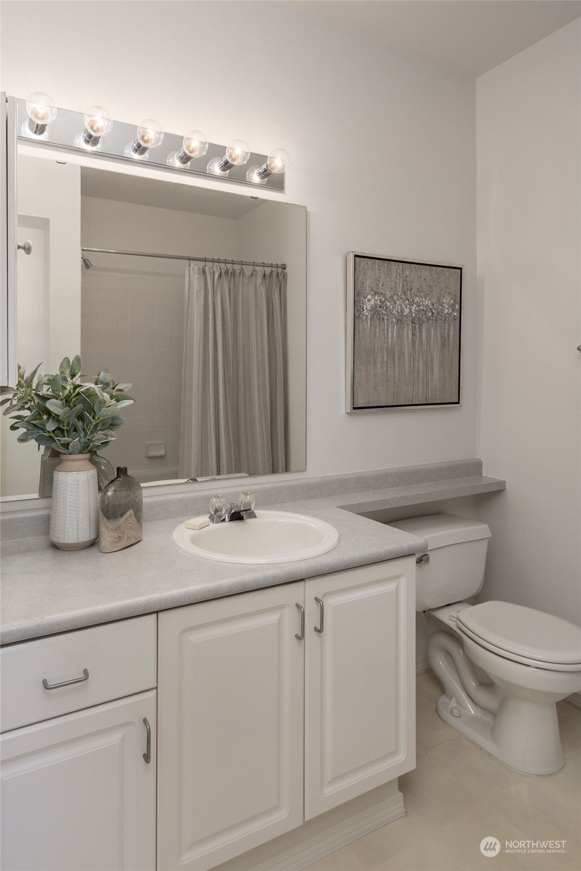 3221 Southwest Avalon Way, Unit 305 Seattle, WA 98126 - Photo 28 of 40 a bathroom with a toilet sink and mirror