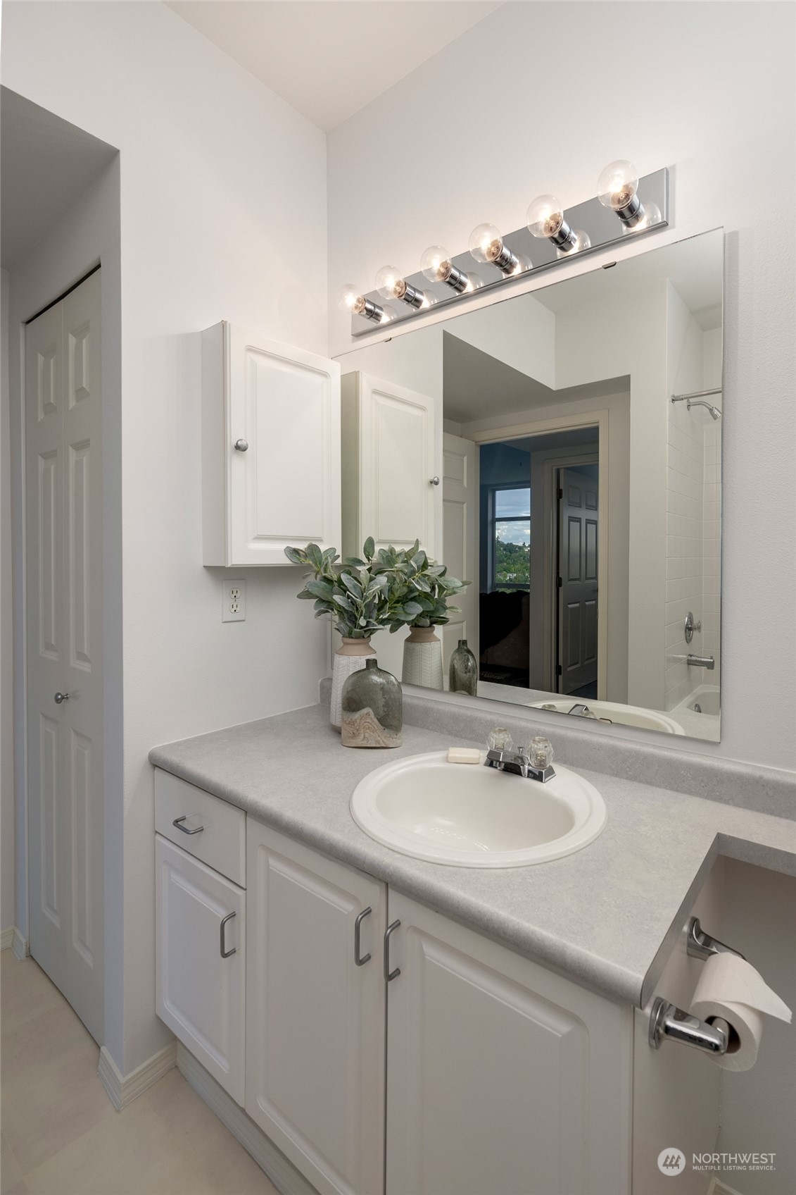 3221 Southwest Avalon Way, Unit 305 Seattle, WA 98126 - Photo 29 of 40 a bathroom with a sink and a mirror