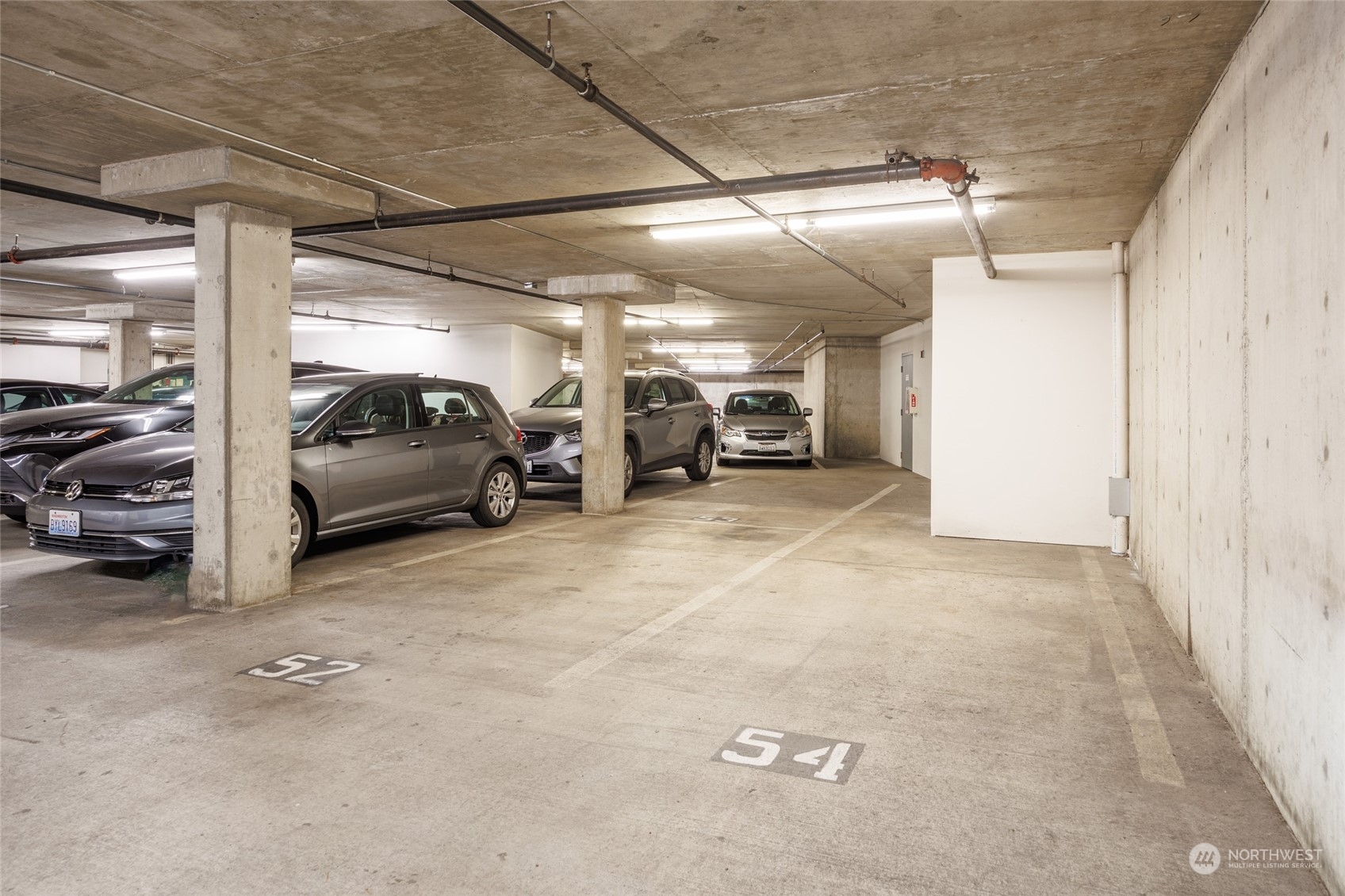 3221 Southwest Avalon Way, Unit 305 Seattle, WA 98126 - Photo 37 of 40 a view of parking garage with cars