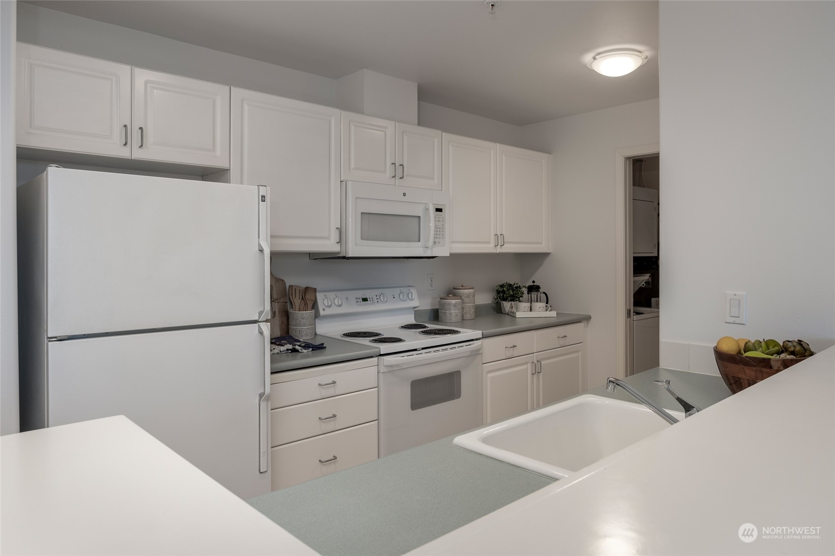 3221 Southwest Avalon Way, Unit 305 Seattle, WA 98126 - Photo 8 of 40 a white refrigerator freezer sitting in a kitchen