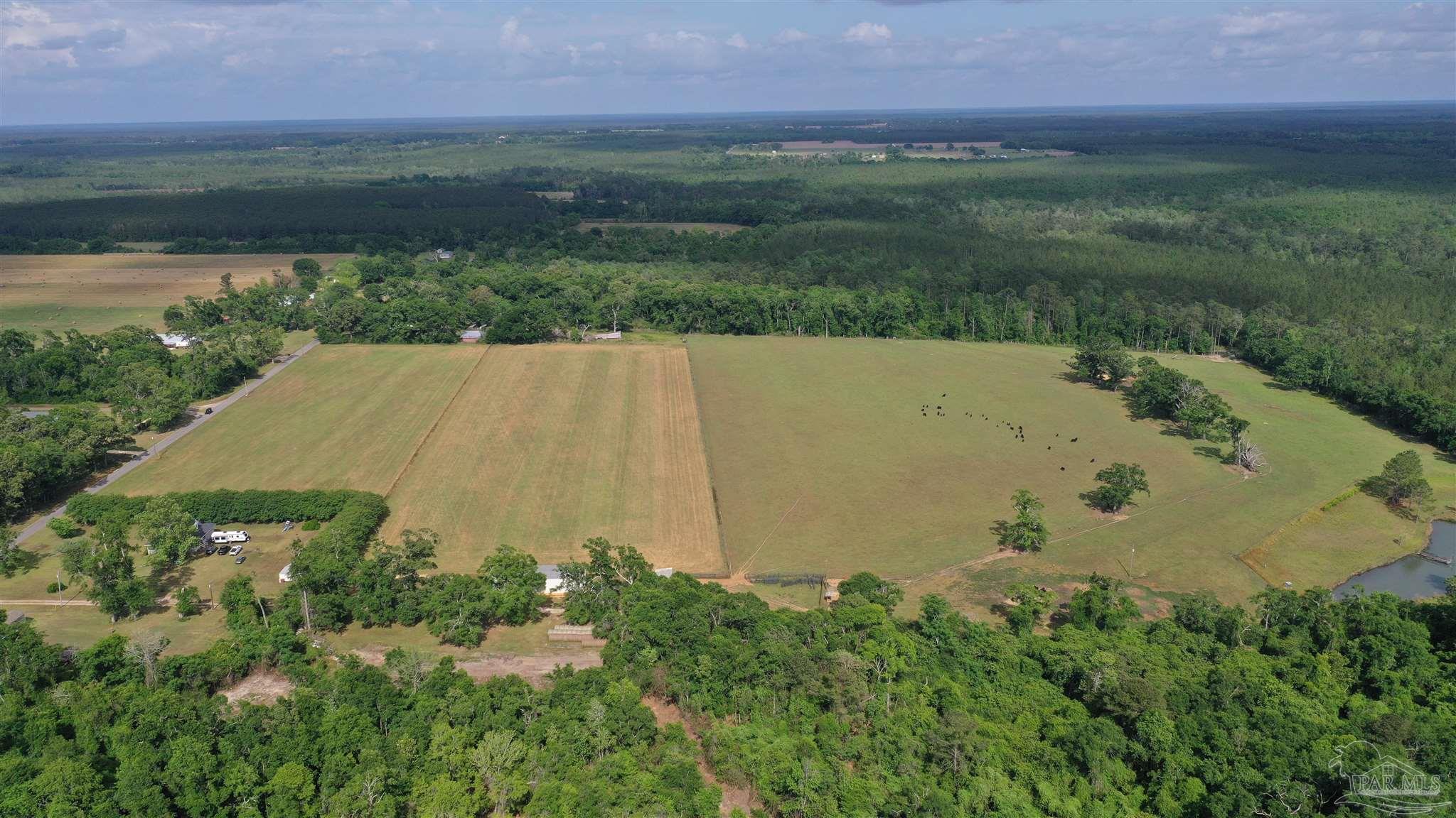 an aerial view of a houses with a yard