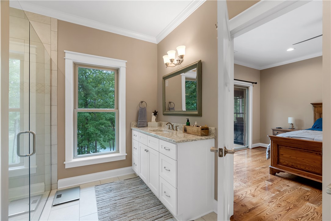 329 High Hampton Road Salem, SC 29676 - Photo 22 of 47 Crown molding and large windows elevate this functional bath featuring an adjoining bedroom suite.