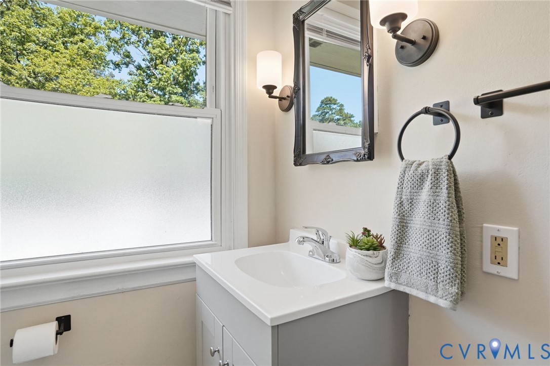 2403 Omega Road Henrico, VA 23228 - Photo 27 of 39 a bathroom with a sink a mirror and a window