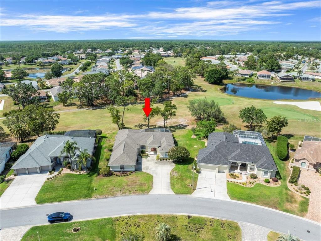 an aerial view of residential houses with outdoor space and lake view