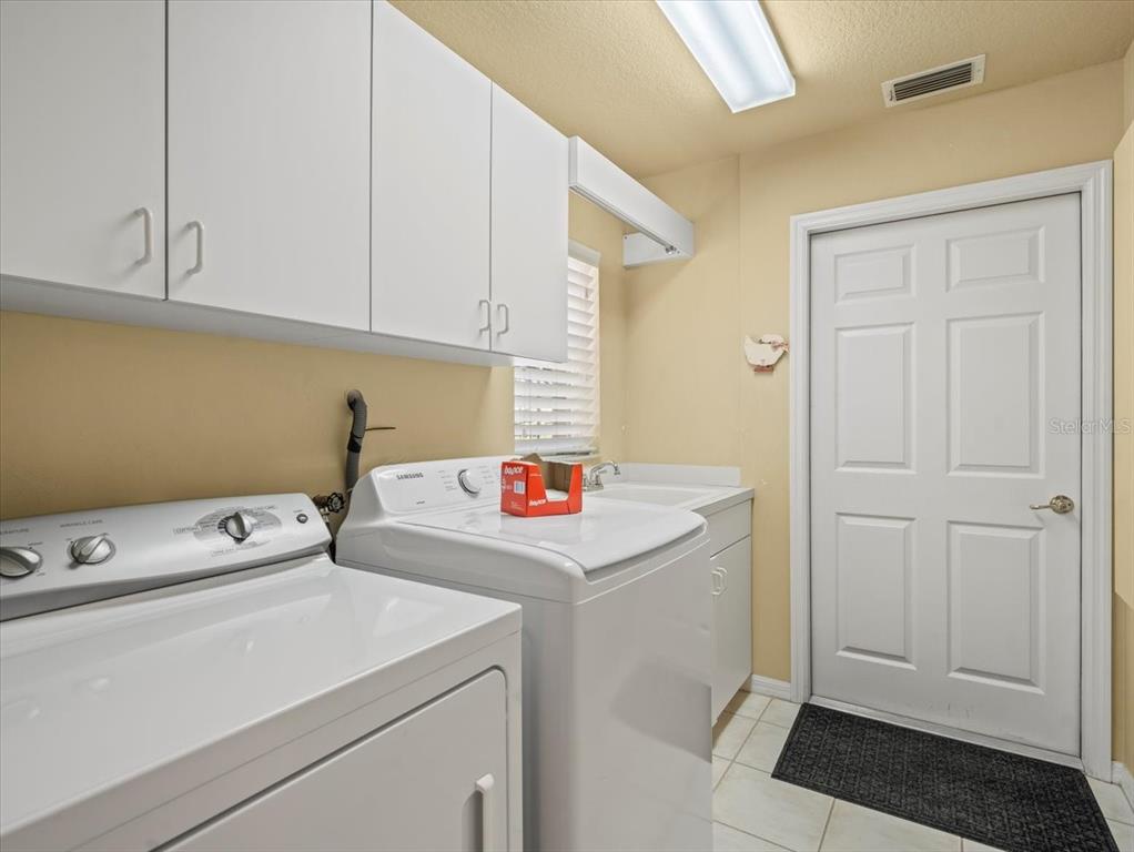 9216 Tarleton Circle Weeki Wachee, FL 34613 - Photo 22 of 66 a utility room with dryer and washer