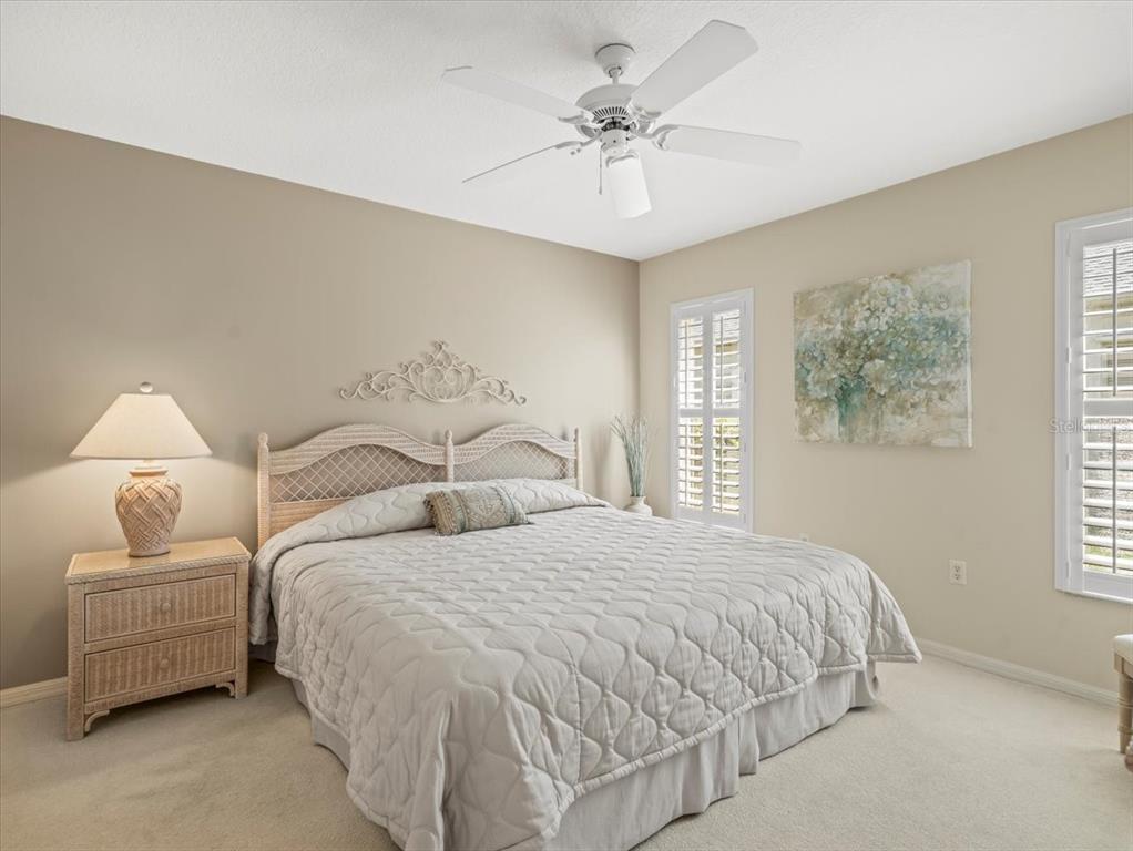 9216 Tarleton Circle Weeki Wachee, FL 34613 - Photo 24 of 66 a bedroom with a bed and a chandelier