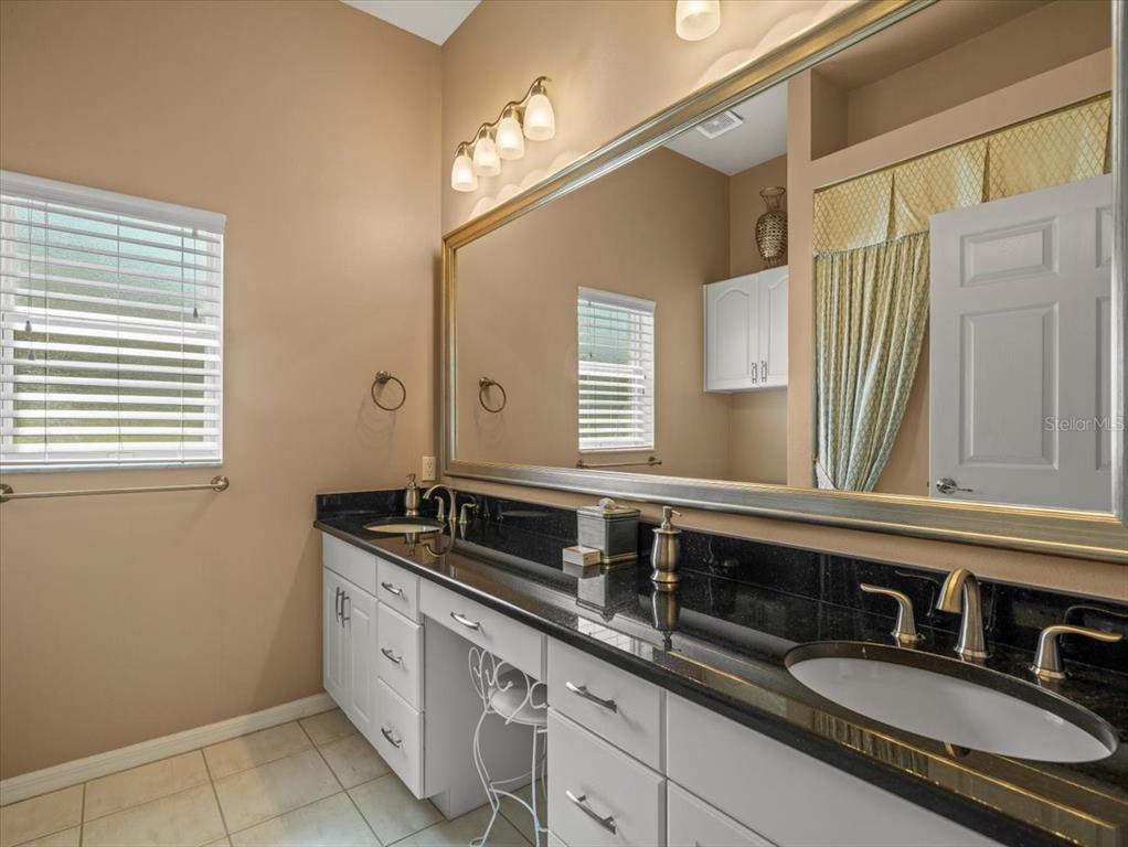 9216 Tarleton Circle Weeki Wachee, FL 34613 - Photo 26 of 66 a bathroom with a sink double vanity granite and a mirror