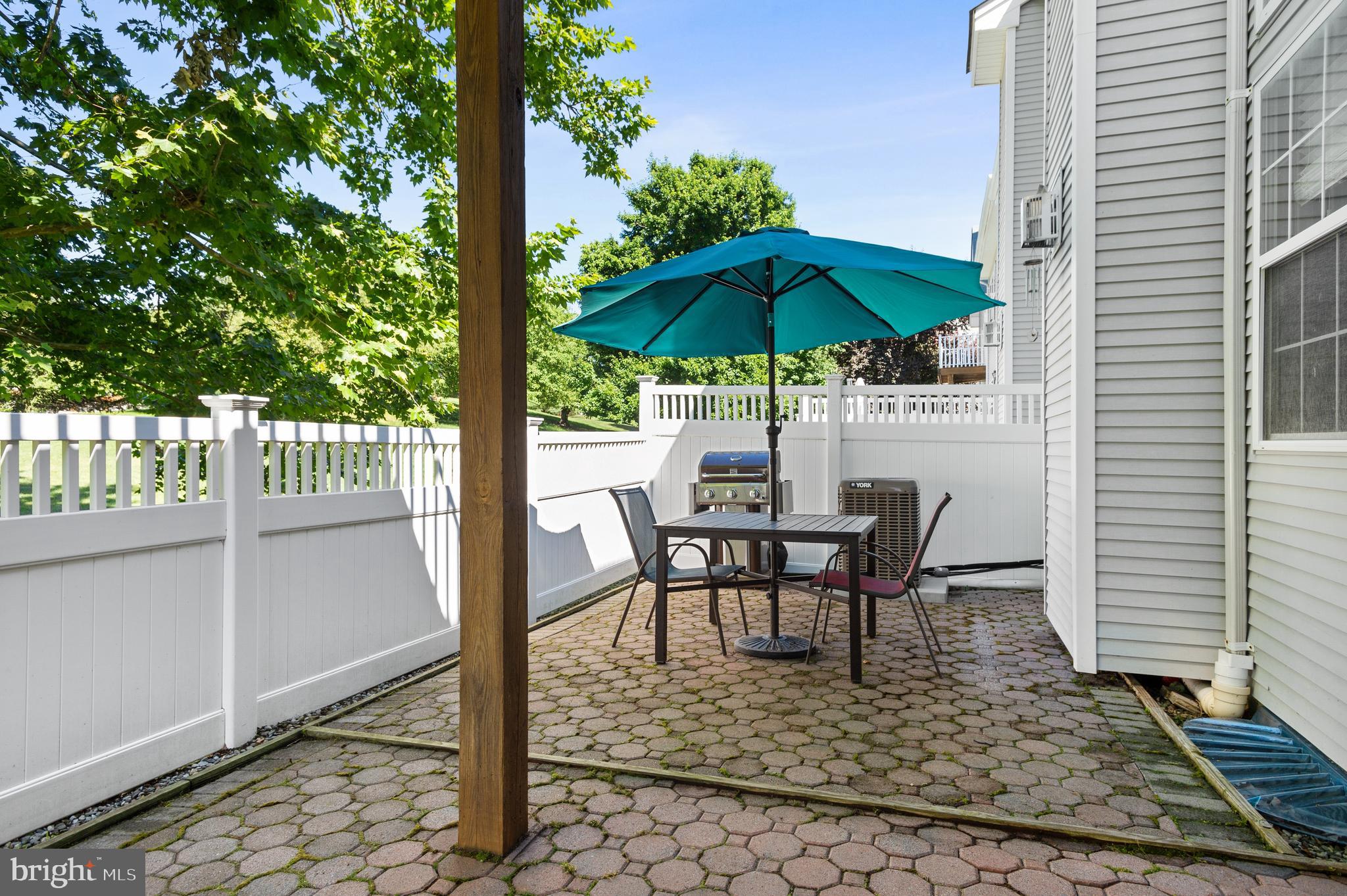 339 Watkins Road Pennington, NJ 08534 - Photo 27 of 32 a view of a roof deck with table and chairs under an umbrella