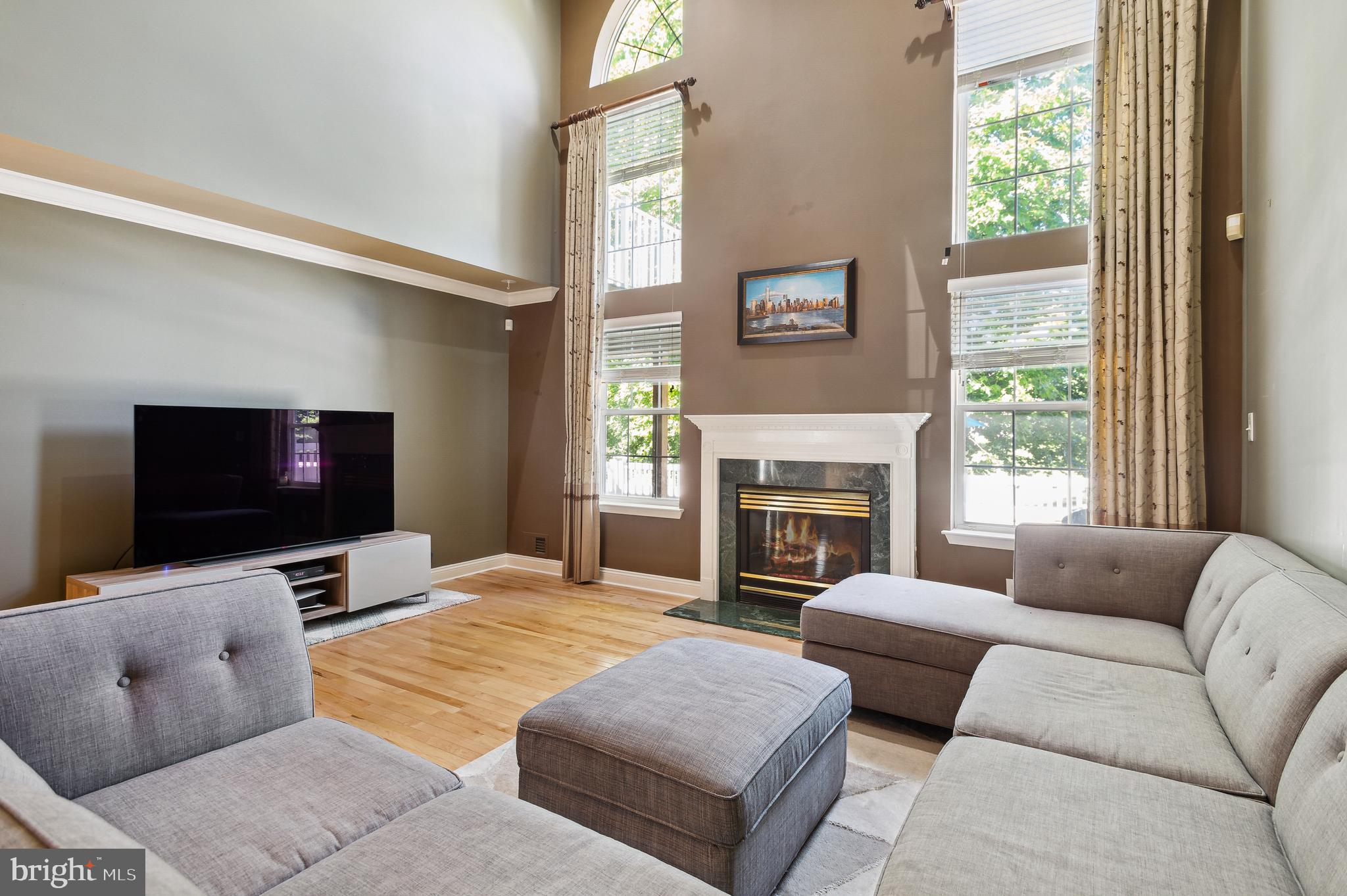 339 Watkins Road Pennington, NJ 08534 - Photo 7 of 32 a living room with furniture a flat screen tv and a fireplace