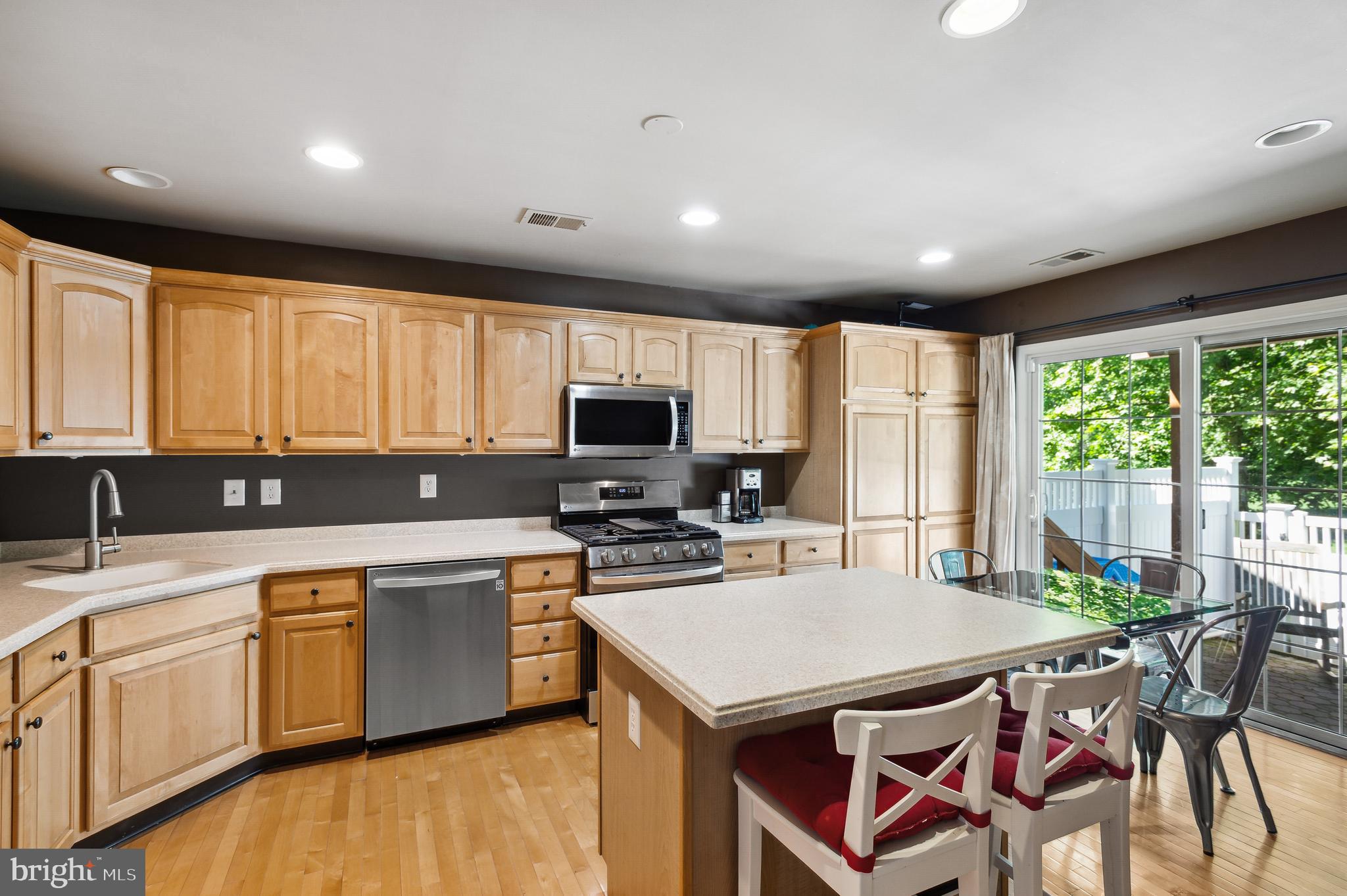 339 Watkins Road Pennington, NJ 08534 - Photo 9 of 32 a kitchen with a stove a sink a microwave a dining table and chairs