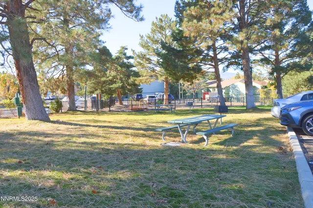 a view of yard with swimming pool and trees