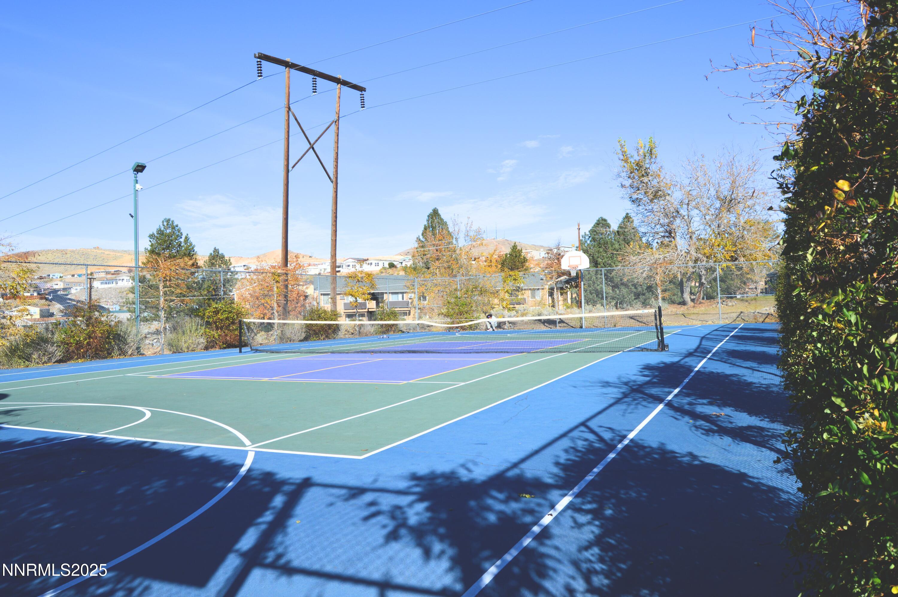 3915 Clear Acre Lane, Unit 149 Reno, NV 89512 - Photo 12 of 16 a view of a tennis ground with large trees