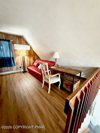 a room with wooden floor and furniture