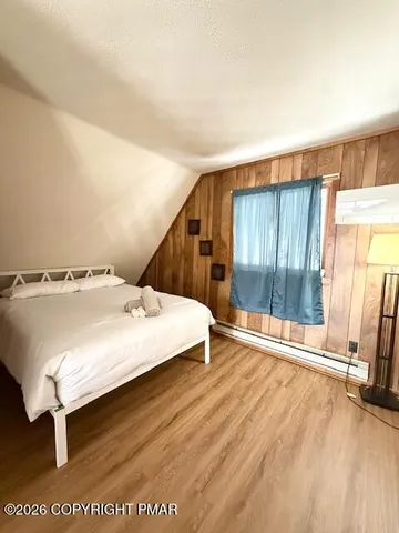 a spacious bedroom with a bed and a window