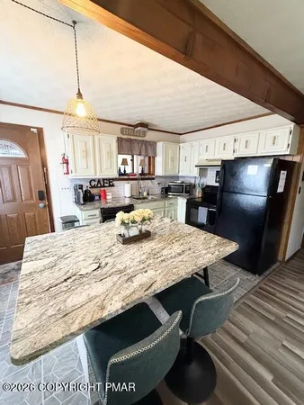 a dining table with chairs and window