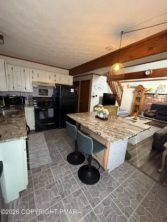 a kitchen with stainless steel appliances granite countertop a stove and a sink