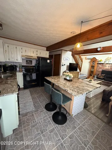 a kitchen with stainless steel appliances granite countertop a stove and a sink