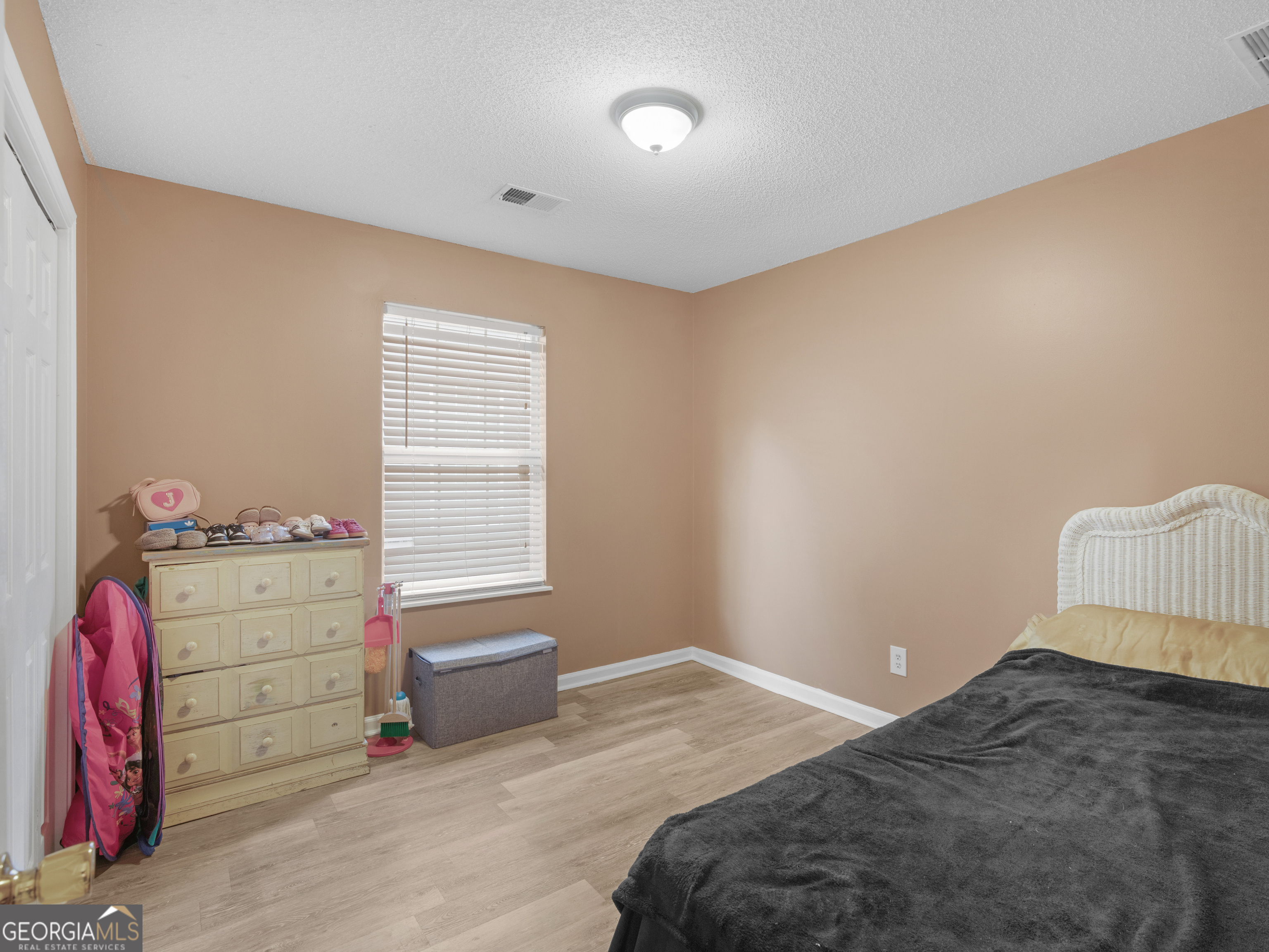 203 Pine Street Zebulon, GA 30295 - Photo 12 of 21 a bedroom with a bed and a window