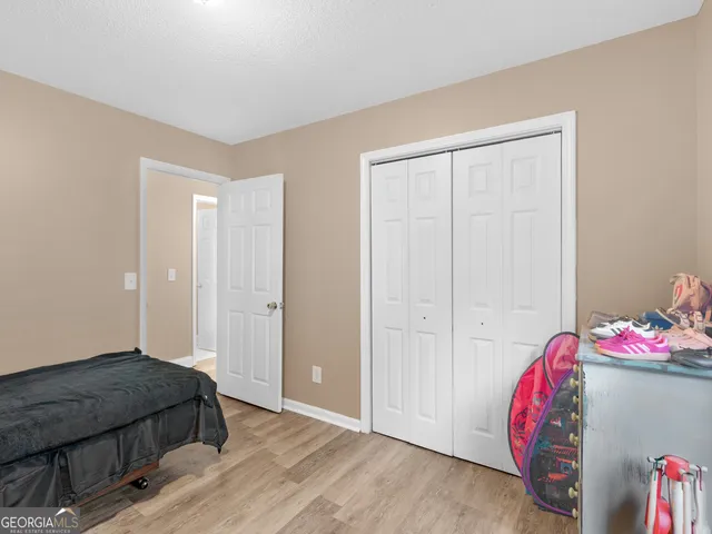 a bedroom with a bed and a closet