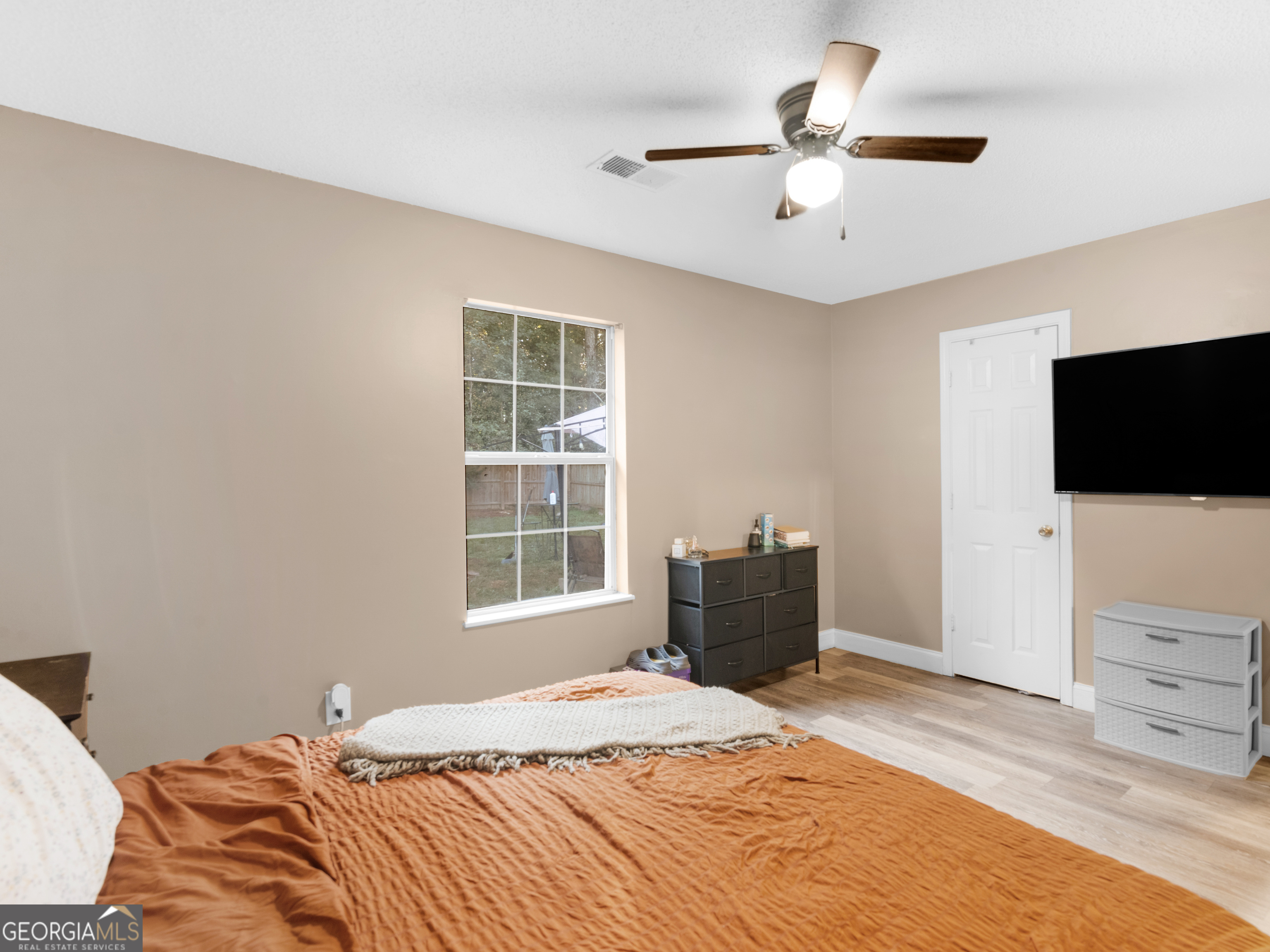 203 Pine Street Zebulon, GA 30295 - Photo 20 of 21 a bedroom with a bed and a flat screen tv