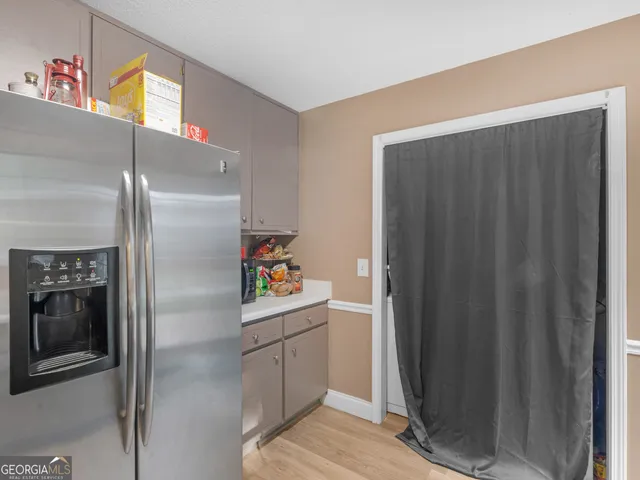 a room with refrigerator and window