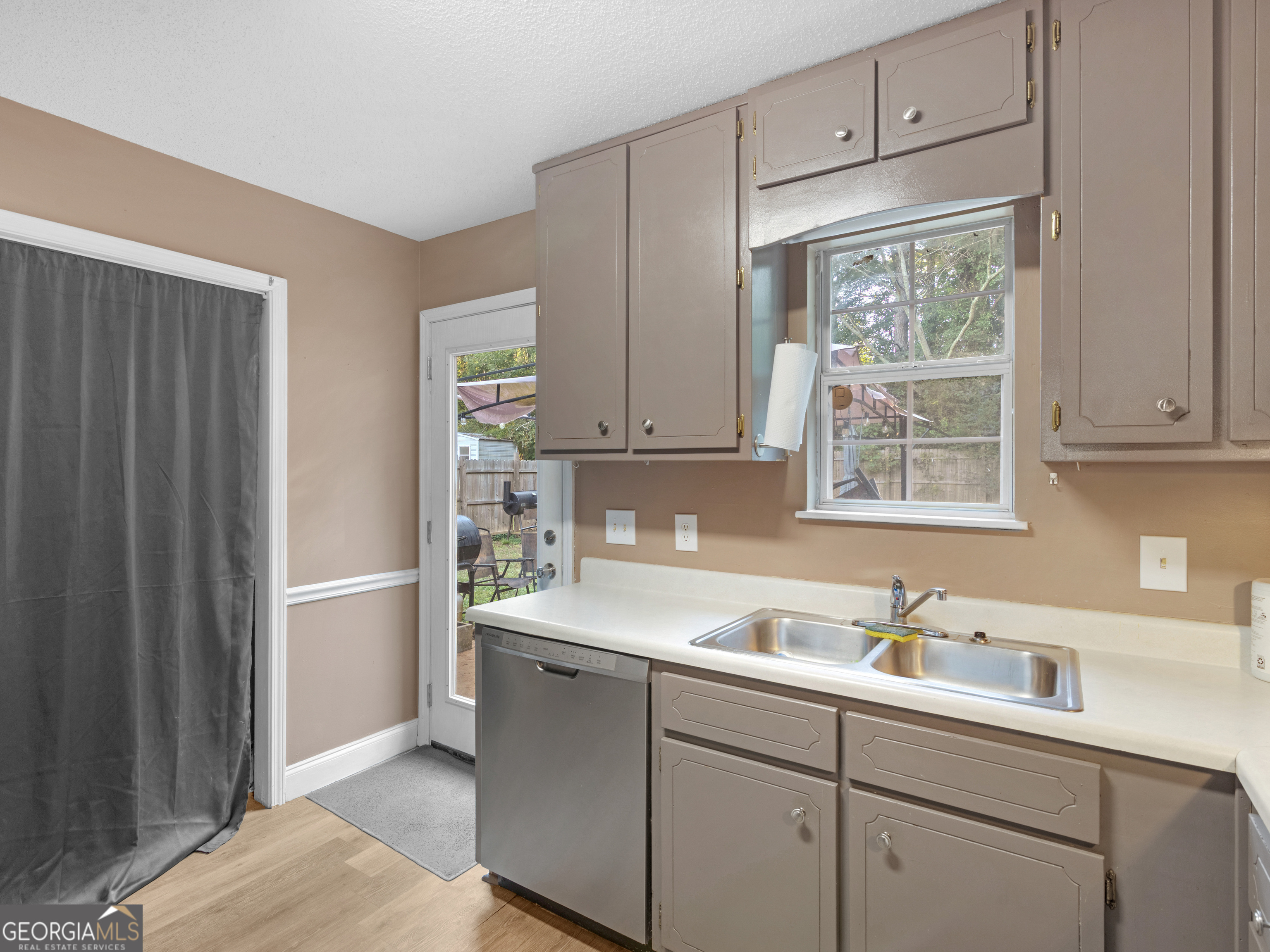 203 Pine Street Zebulon, GA 30295 - Photo 9 of 21 a kitchen with a sink cabinets appliances and a window