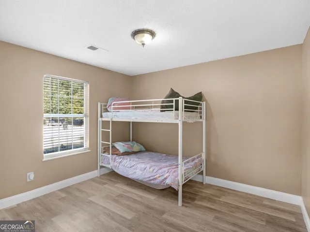 a bedroom with a bed and window