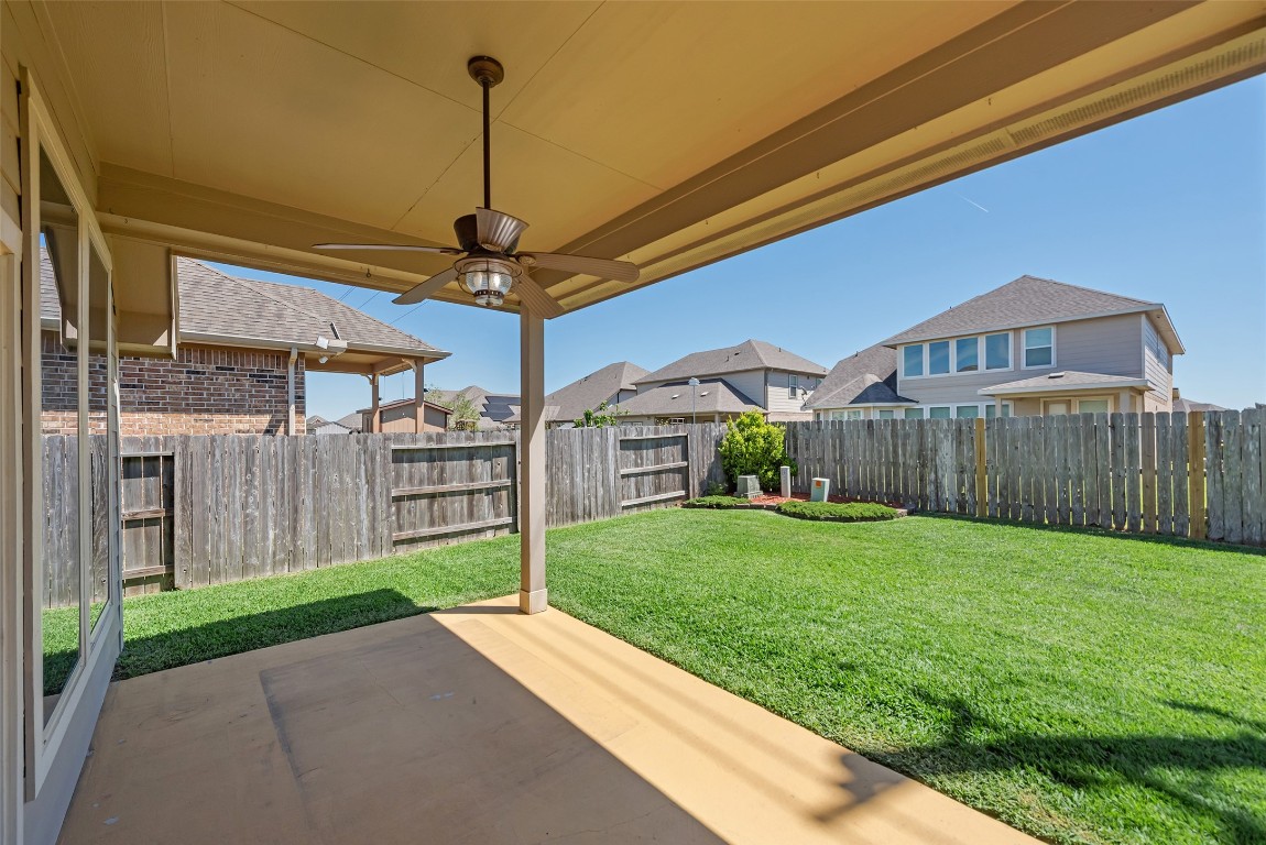 1908 Rushing Meadow Lane Pearland, TX 77089 - Photo 29 of 31 Lighted ceiling fan & it overlooks the lovely backyard!