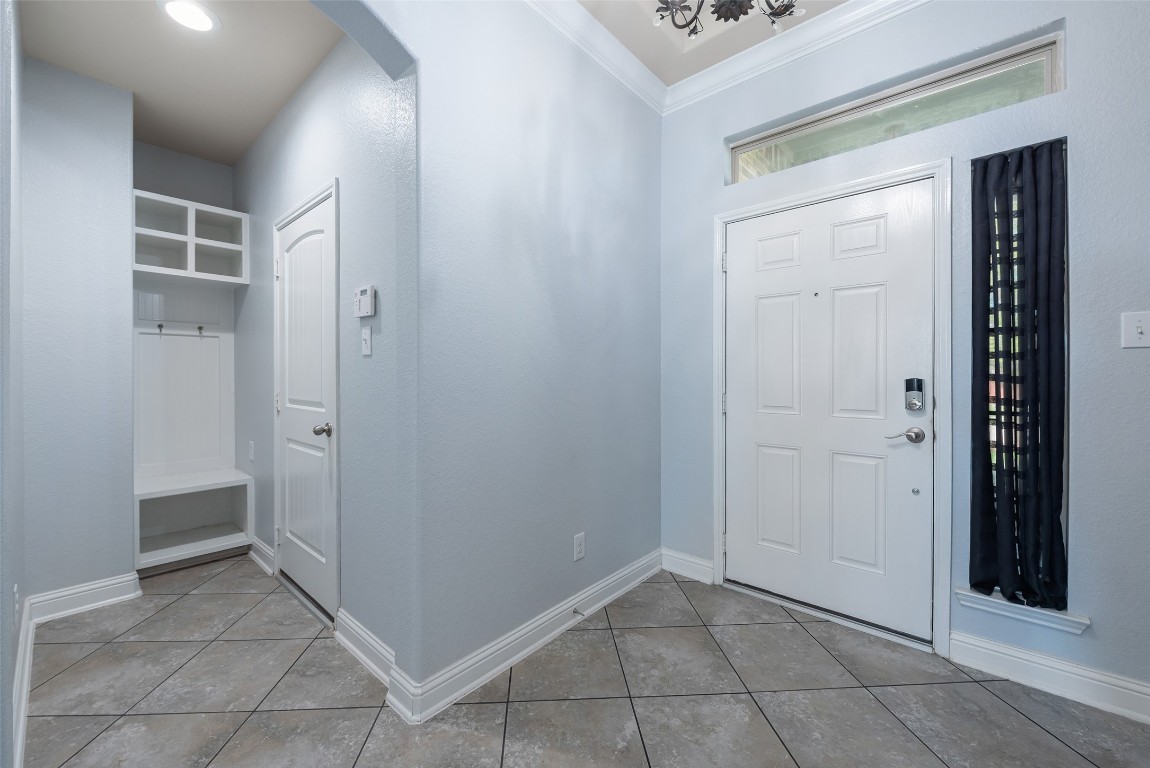 1908 Rushing Meadow Lane Pearland, TX 77089 - Photo 5 of 31 Front door opens to convenient drop station with coat bench and storage cubbies.