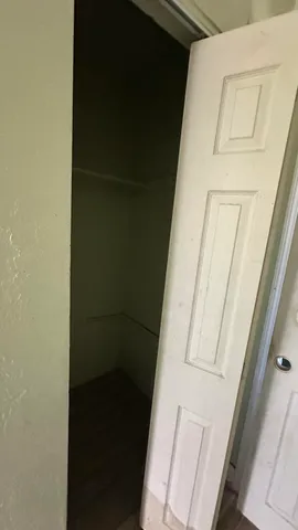 a picture of a room with a ceiling fan and a window