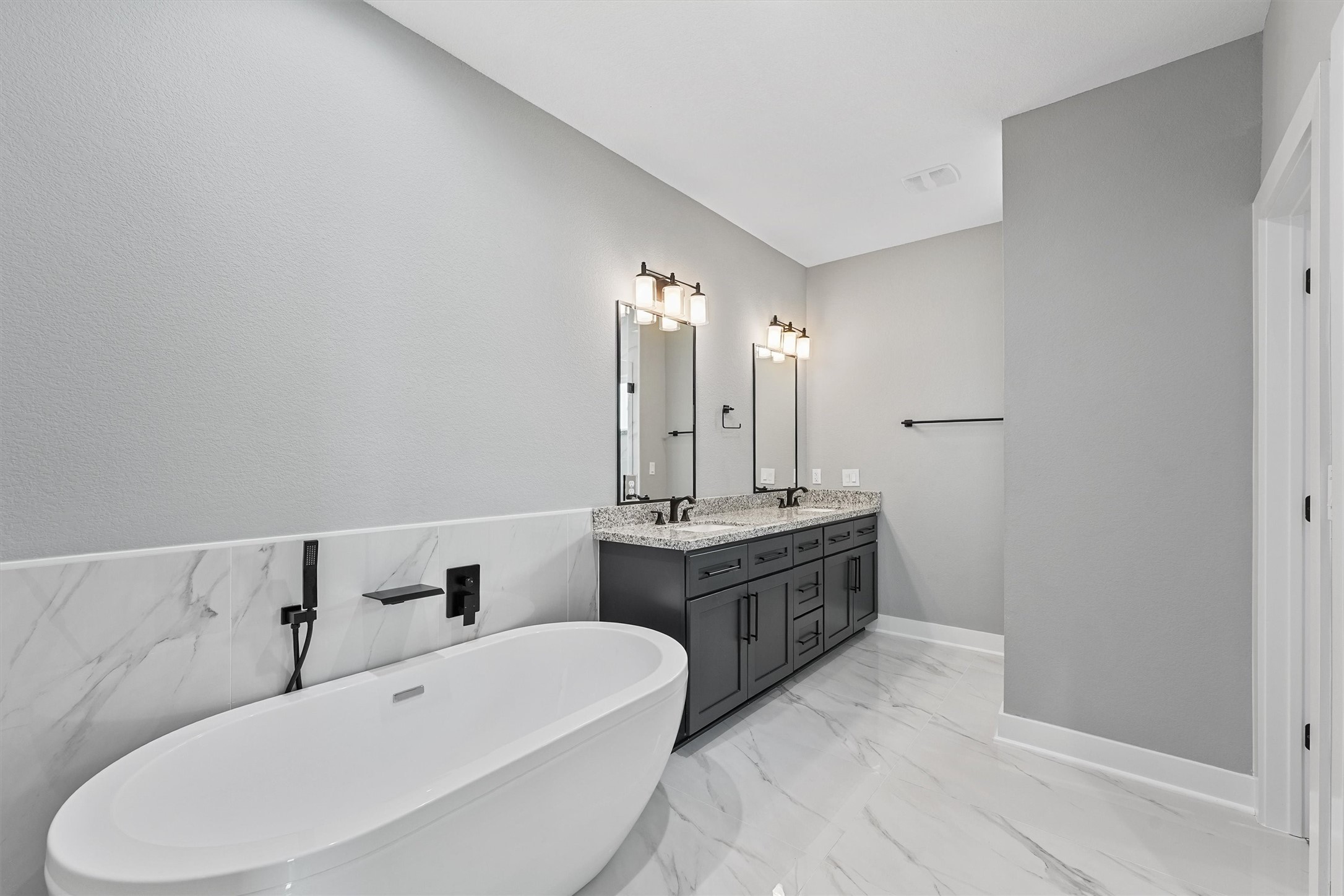 7704 Sealey Street Houston, TX 77088 - Photo 9 of 15 a spacious bathroom with a bathtub sink and mirror