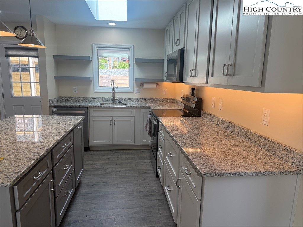 174 Spruce Pine Road Newland, NC 28657 - Photo 13 of 41 a kitchen with stainless steel appliances granite countertop a sink stove and cabinets